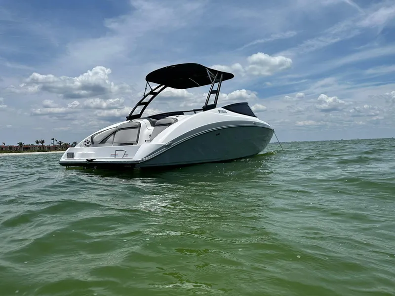 Slide: The Image of 2020 Yamaha AR240 boat on calm water under a partly cloudy sky. - 3