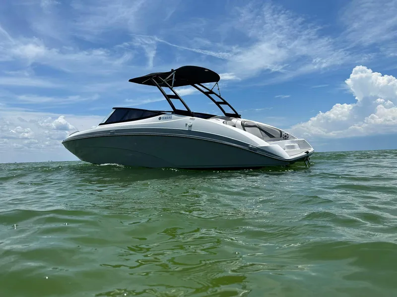 Slide: The Image of 2020 Yamaha AR240 boat on calm water under a clear blue sky. - 5