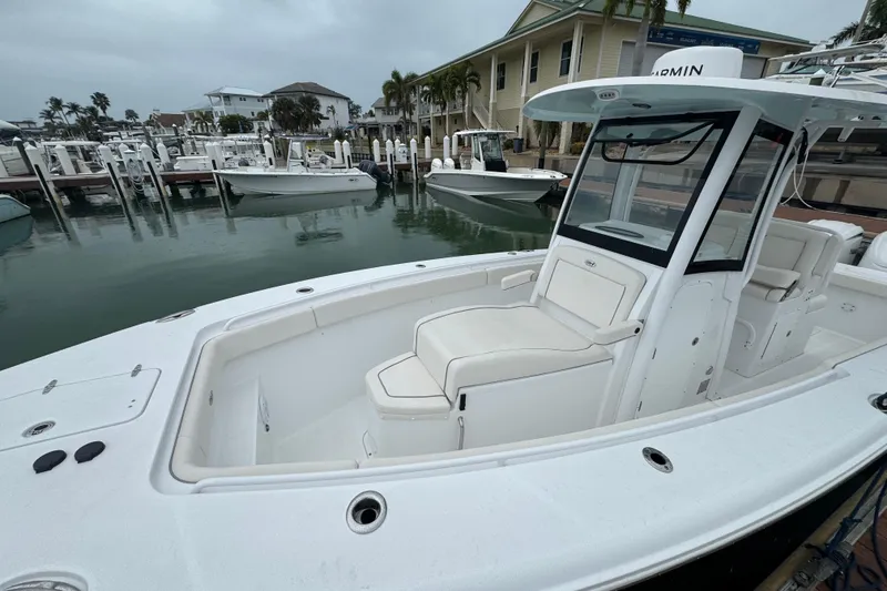 Slide: The Image of 2024 Sea Hunt Gamefish 27 Coffin Box boat docked at marina, showcasing sleek design. - 14
