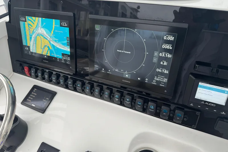 Slide: The Image of 2024 Sea Hunt Gamefish 27 Coffin Box dashboard with Garmin navigation displays. - 16