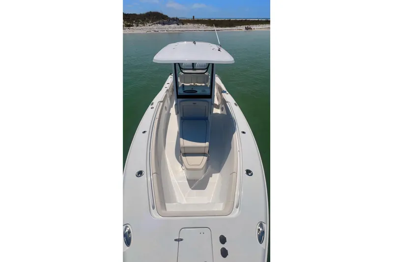 Slide: The Image of 2024 Sea Hunt Gamefish 27 Coffin Box boat on clear water, side view. - 2