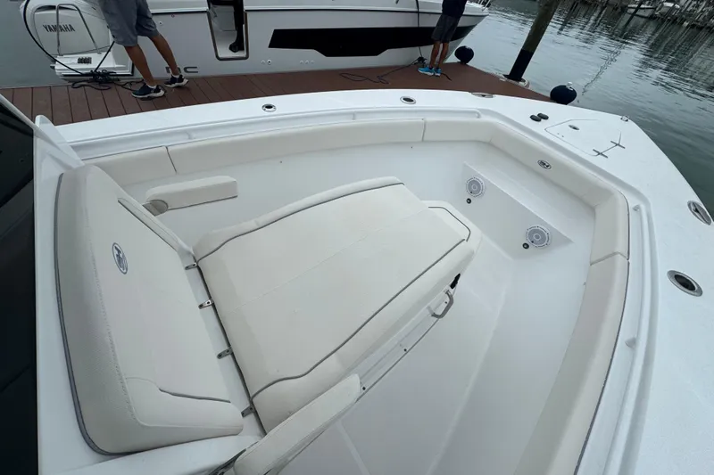 Slide: The Image of 2024 Sea Hunt Gamefish 27 Coffin Box boat interior with seating and speakers. - 21