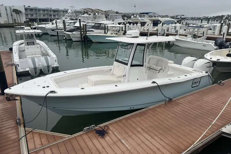Slide: The Image of 2024 Sea Hunt Gamefish 27 Coffin Box boat docked at marina. - 23