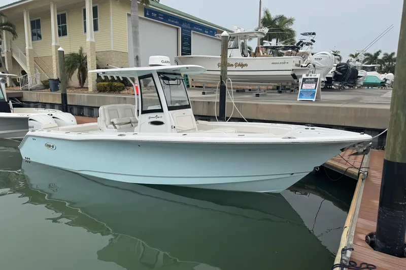 Slide: The Image of 2024 Sea Hunt Gamefish 27 Coffin Box boat docked at marina, side view. - 24