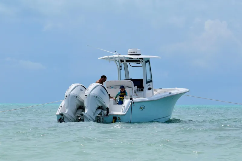 Slide: The Image of 2024 Sea Hunt Gamefish 27 Coffin Box in ocean, people enjoying water activities nearby. - 9