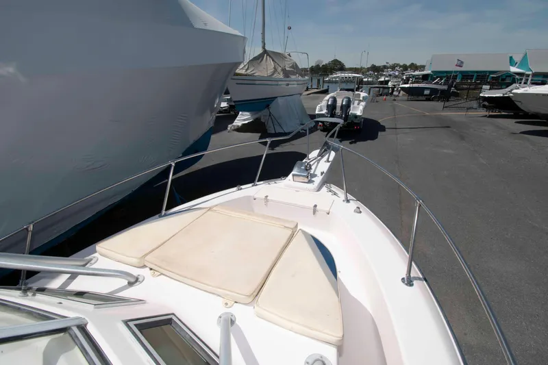 Slide: The Image of 1996 Grady-White Islander 268 boat docked, showcasing cockpit and controls. - 11