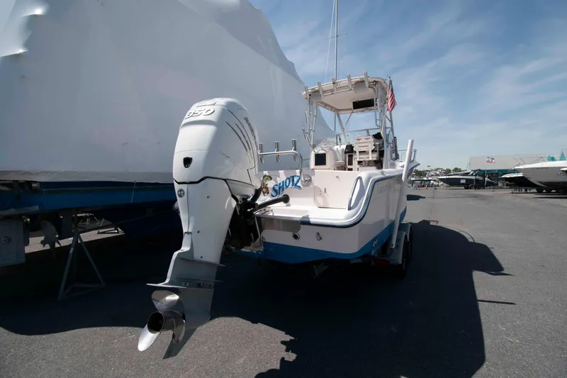 Slide: The Image of 1996 Grady-White Islander 268 boat on trailer, parked outdoors under clear sky. - 3