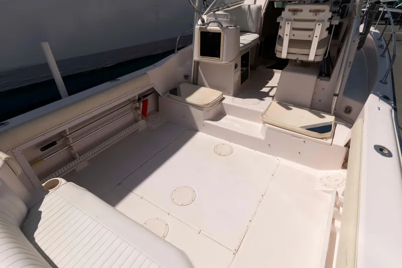 Slide: The Image of 1996 Grady-White Islander 268 boat interior with seating and outboard motor. - 5
