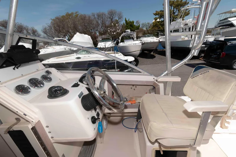 Slide: The Image of 1996 Grady-White Islander 268 boat interior with helm and seating area. - 8