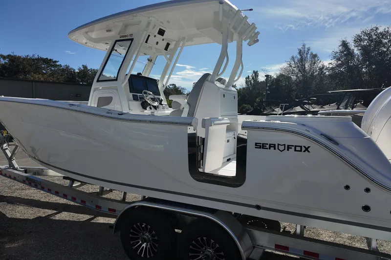 Slide: The Image of 2026 Sea Fox 288 Commander boat on trailer, side view, sunny day. - 12