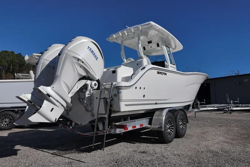 Slide: The Image of 2026 Sea Fox 288 Commander boat on trailer with Yamaha engines, parked outdoors. - 3