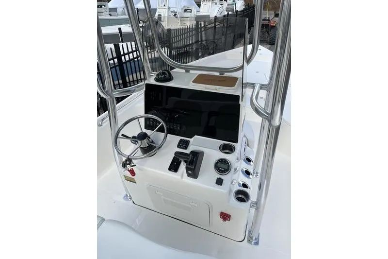 Slide: The Image of 2025 Bulls Bay 2400 boat console with steering wheel and controls. - 10
