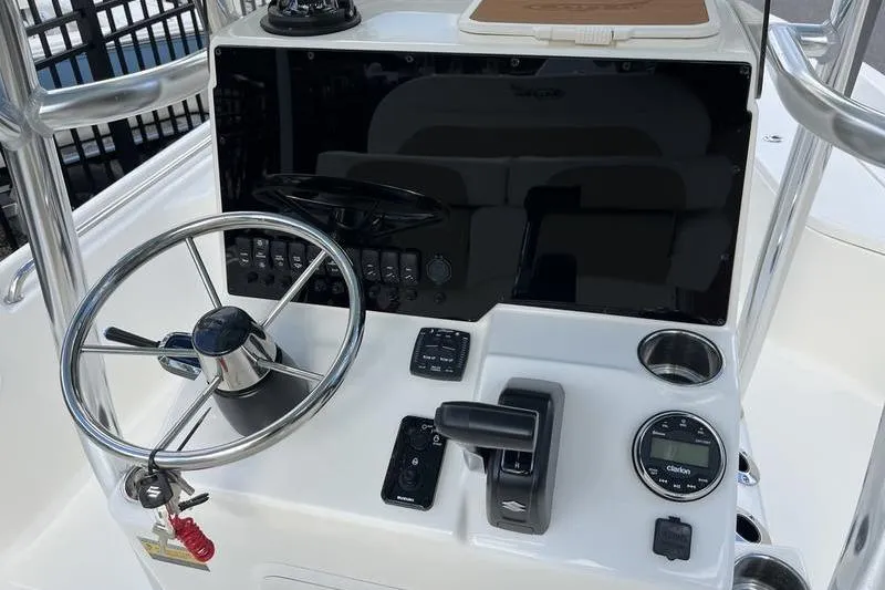 Slide: The Image of 2025 Bulls Bay 2400 boat console with steering wheel and control panel. - 11