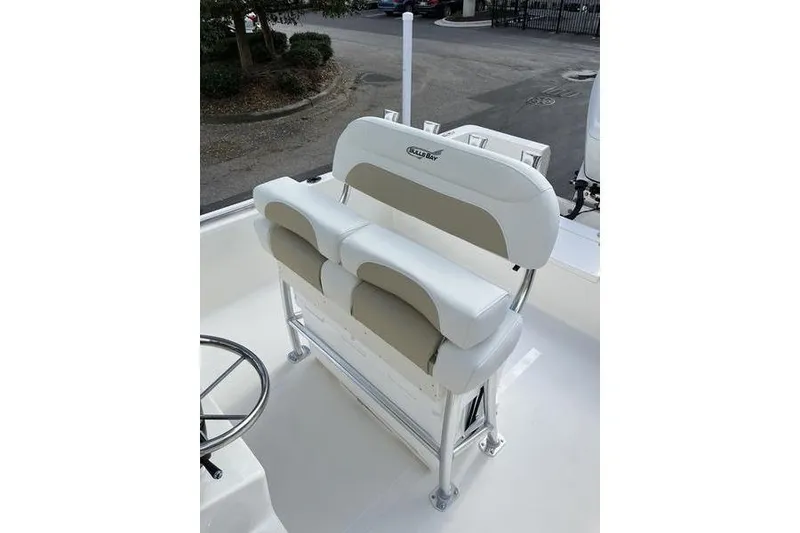 Slide: The Image of 2025 Bulls Bay 2400 boat seating with white and beige cushioned design. - 13