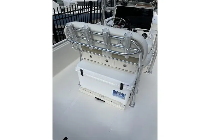 Slide: The Image of 2025 Bulls Bay 2400 boat interior with rod holders and storage compartments. - 14