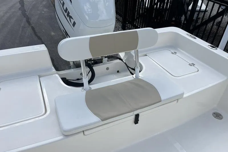 Slide: The Image of 2025 Bulls Bay 2400 boat seating area with Suzuki engine in background. - 16