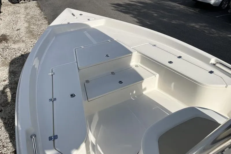 Slide: The Image of 2025 Bulls Bay 2400 boat interior with storage compartments and seating. - 6