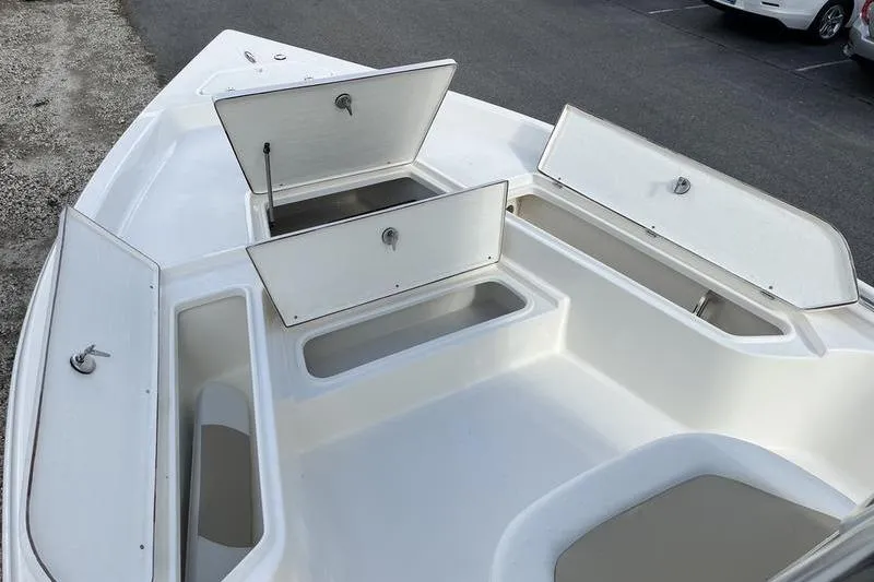 Slide: The Image of 2025 Bulls Bay 2400 boat with open storage compartments on deck. - 8
