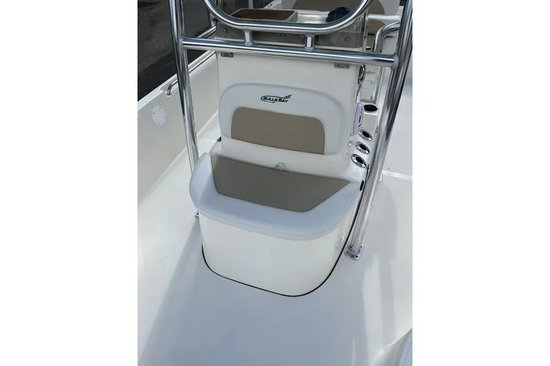 Slide: The Image of 2025 Bulls Bay 2400 boat seating area with stainless steel frame and beige cushions. - 9