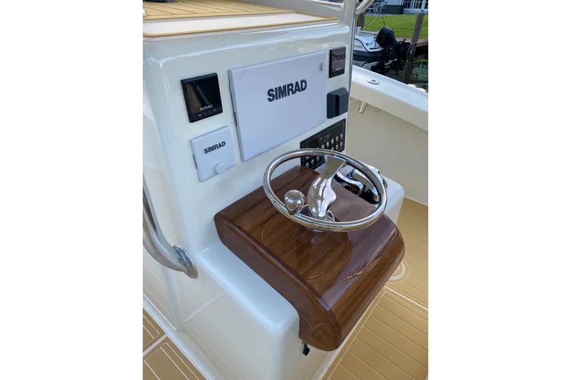 Slide: The Image of 2019 Custom Carolina boat helm with Simrad electronics and polished wood finish. - 10