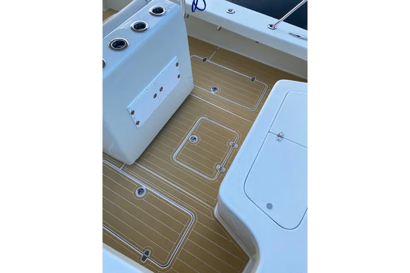 Slide: The Image of 2019 Custom Carolina boat deck with tan flooring and white fixtures. - 16