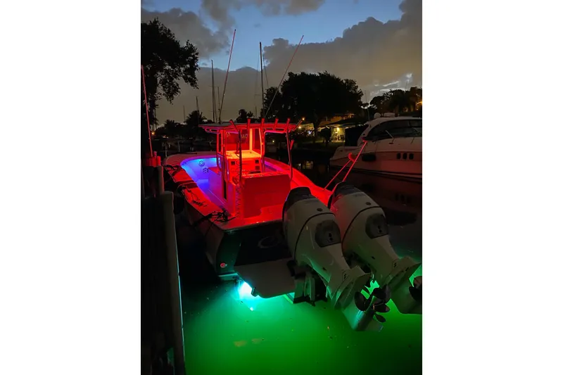 Slide: The Image of 2019 Custom Carolina boat with vibrant red and green lights docked at night. - 18