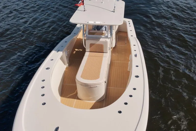 Slide: The Image of 2019 Custom Carolina boat with spacious deck and seating on calm water. - 8