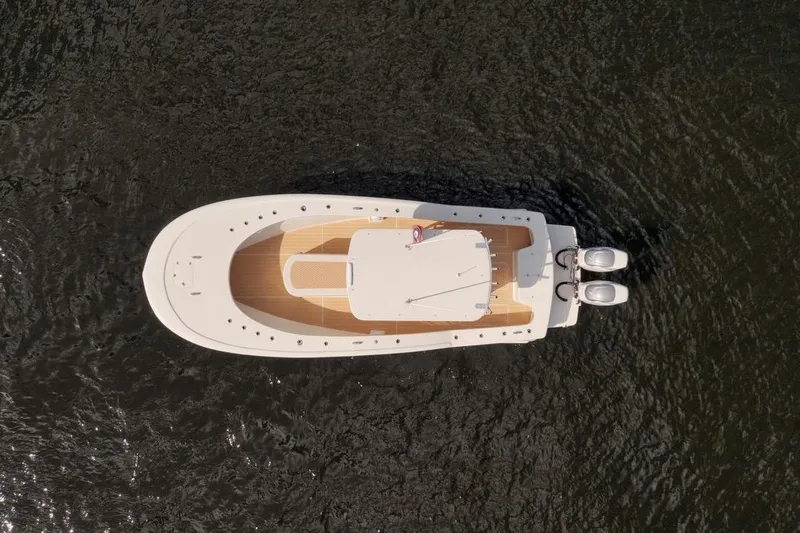 Slide: The Image of Aerial view of 2019 Custom Carolina boat with twin engines on water. - 13
