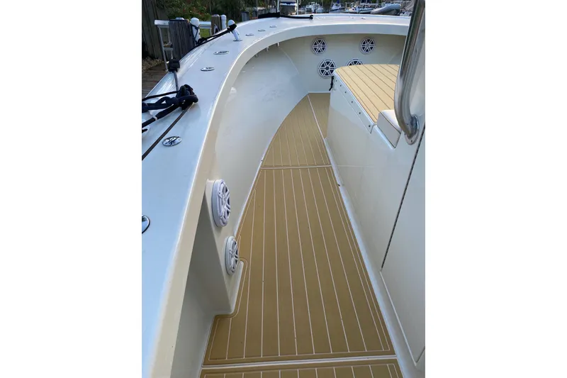 Slide: The Image of 2019 Custom Carolina boat deck with speakers and wood-like flooring. - 17
