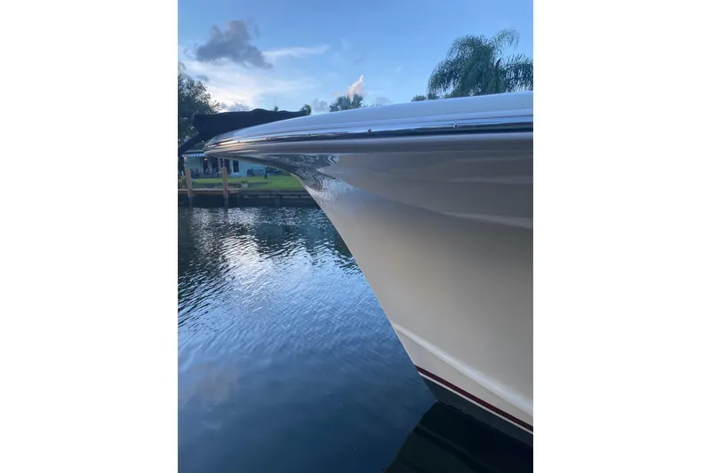 Slide: The Image of 2019 Custom Carolina boat bow reflecting on calm water at sunset. - 19
