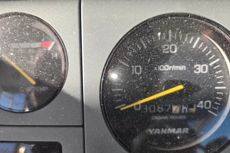 Slide: The Image of Close-up of Henriques 35 Flybridge 2001 engine gauges, showing RPM and temperature. - 11