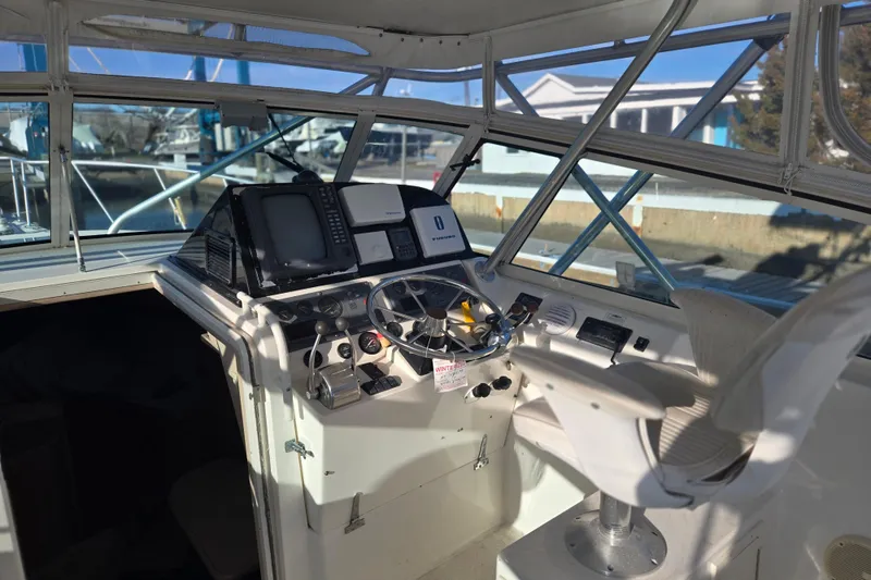 Slide: The Image of Helm of 2001 Henriques 35 Flybridge with navigation equipment and captain's chair. - 3