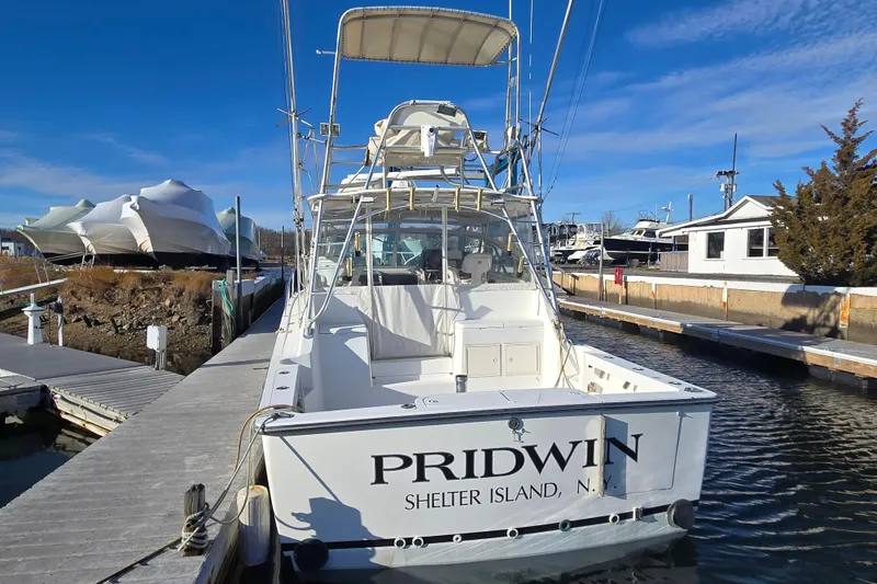 Slide: The Image of Henriques 35 Flybridge 2001 docked at Shelter Island marina under clear blue skies. - 9