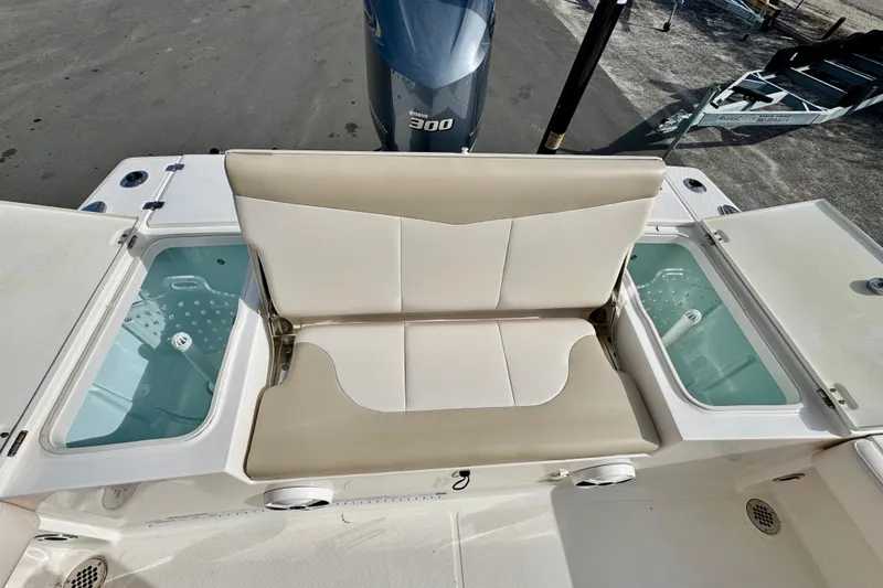 Slide: The Image of 2017 Robalo 246 Cayman boat with cushioned seating and storage compartments. - 11