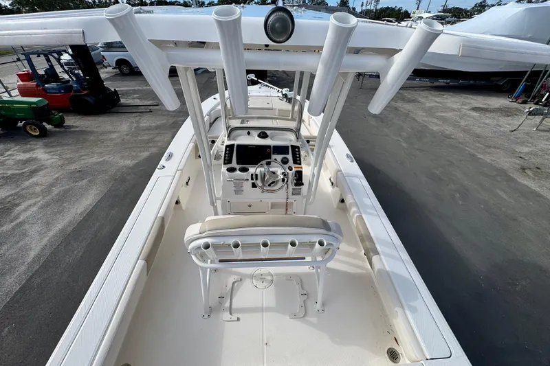 Slide: The Image of 2017 Robalo 246 Cayman boat interior with steering console and rod holders. - 12