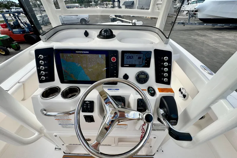 Slide: The Image of 2017 Robalo 246 Cayman boat dashboard with navigation and control systems. - 15