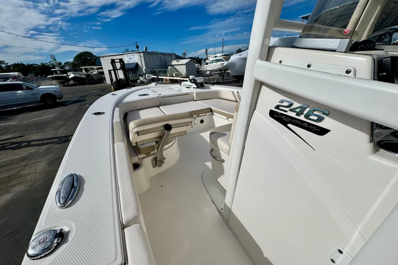 Slide: The Image of 2017 Robalo 246 Cayman boat, white interior, docked outdoors under blue sky. - 18