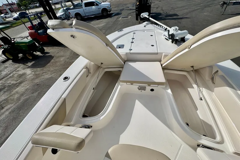 Slide: The Image of 2017 Robalo 246 Cayman boat interior with open storage compartments and seating. - 20