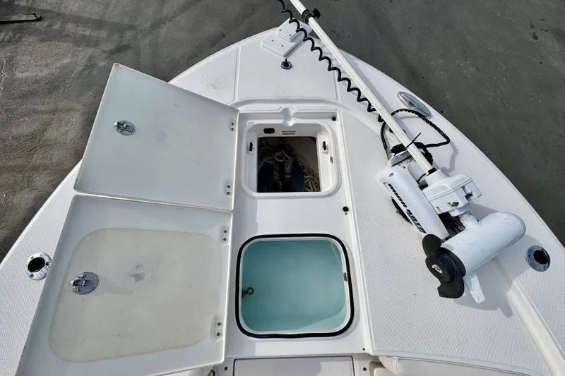 Slide: The Image of 2017 Robalo 246 Cayman boat deck with storage compartments and trolling motor. - 21