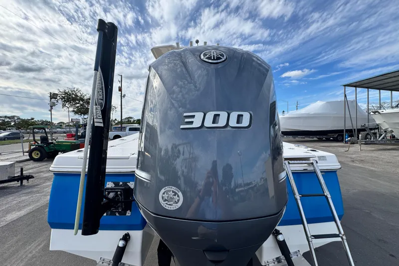 Slide: The Image of 2017 Robalo 246 Cayman boat with Yamaha 300 outboard motor, parked outdoors. - 29