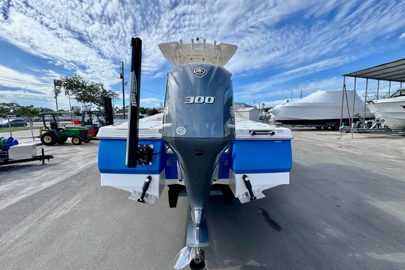 Slide: The Image of 2017 Robalo 246 Cayman boat with Yamaha 300 engine, parked outdoors under a blue sky. - 3