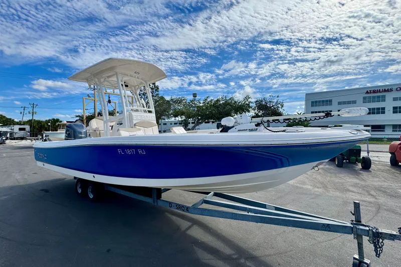 Slide: The Image of 2017 Robalo 246 Cayman boat on trailer under blue sky. - 6