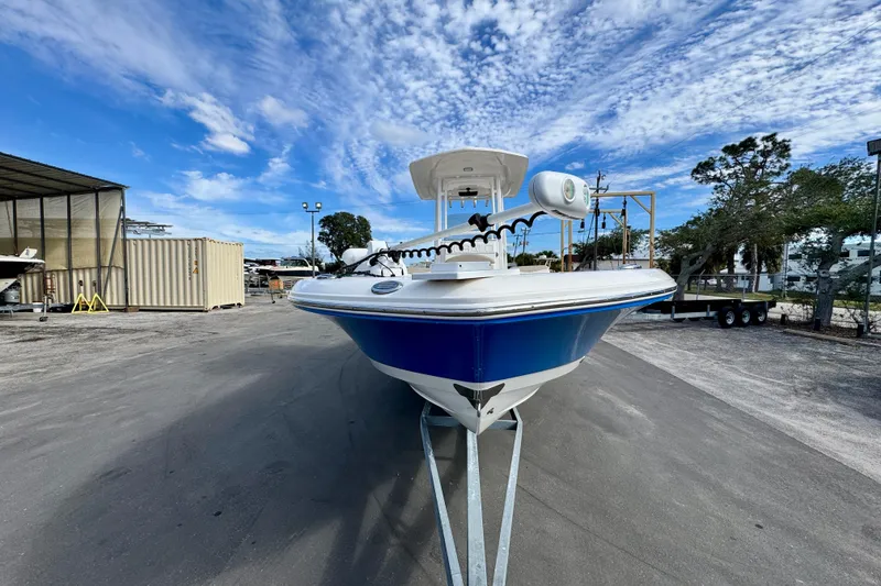 Slide: The Image of 2017 Robalo 246 Cayman boat on trailer under a vibrant blue sky. - 7