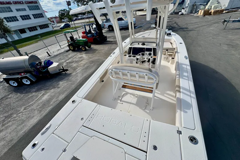 Slide: The Image of 2017 Robalo 246 Cayman boat, white interior, parked outdoors near office complex. - 9