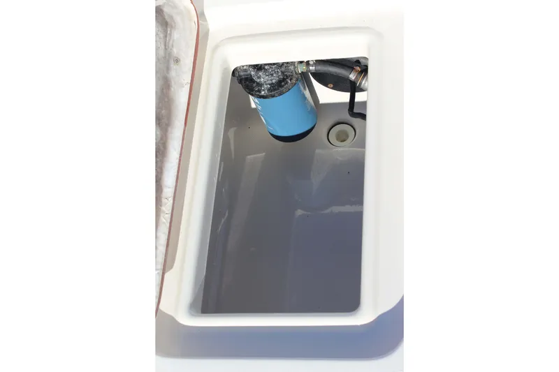 Slide: The Image of Open compartment of 2017 Bulls Bay 2000 boat showing interior and filter. - 12