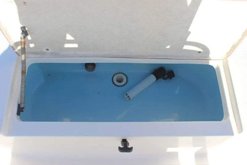 Slide: The Image of Livewell compartment in a 2017 Bulls Bay 2000 boat, featuring a blue interior. - 13
