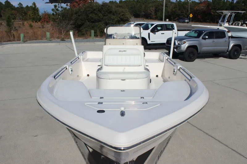 Slide: The Image of 2017 Bulls Bay 2000 boat, white interior, parked outdoors with trucks in the background. - 2