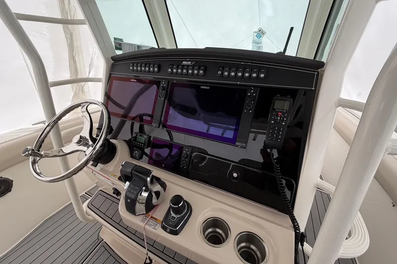 Slide: The Image of 2018 Boston Whaler 330 Outrage helm with advanced navigation and control systems. - 16