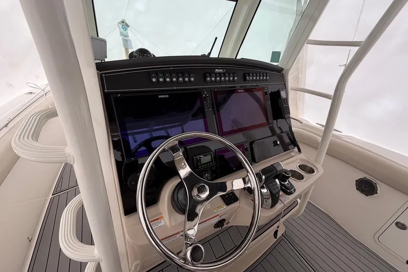 Slide: The Image of 2018 Boston Whaler 330 Outrage helm with advanced navigation and control systems. - 18