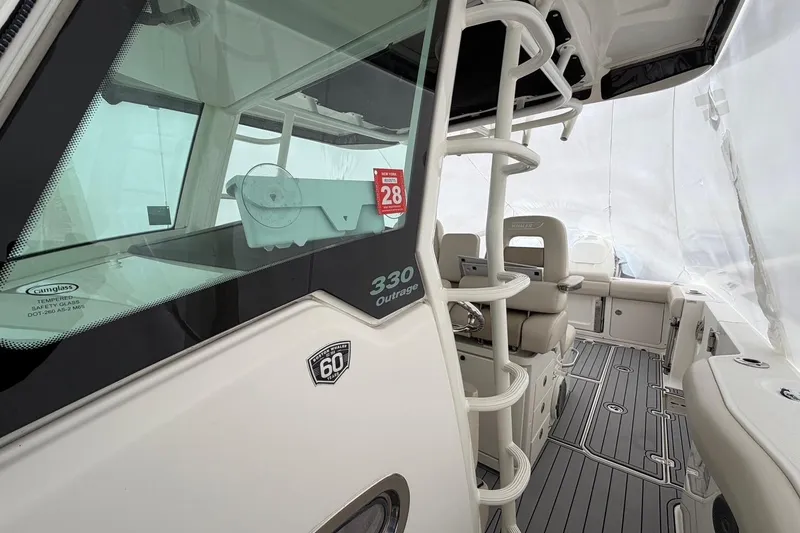 Slide: The Image of 2018 Boston Whaler 330 Outrage boat interior with seating and helm station. - 20